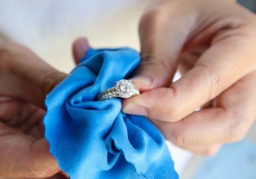 hands holding a ring - jewelers block coverage